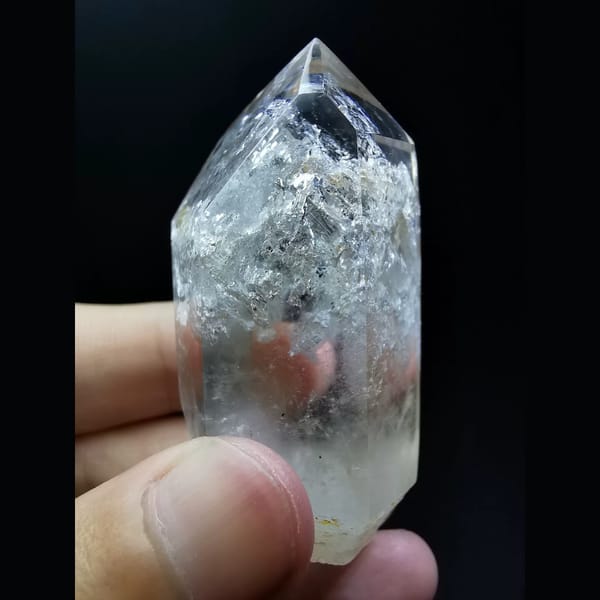 Polished enhydro clear quartz point with a water bubble — alternate view