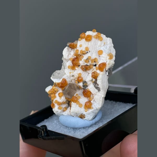 Orange spessartine garnets on feldspar with quartz from Yunxiao, Fujian — detail view