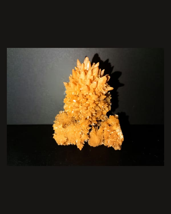 Complete front view of the orange crystallized mineral cluster from Yunnan