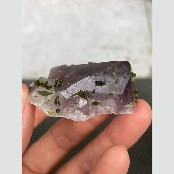 Lilac-tinted quartz with dark green epidote from Sichuan — detail view