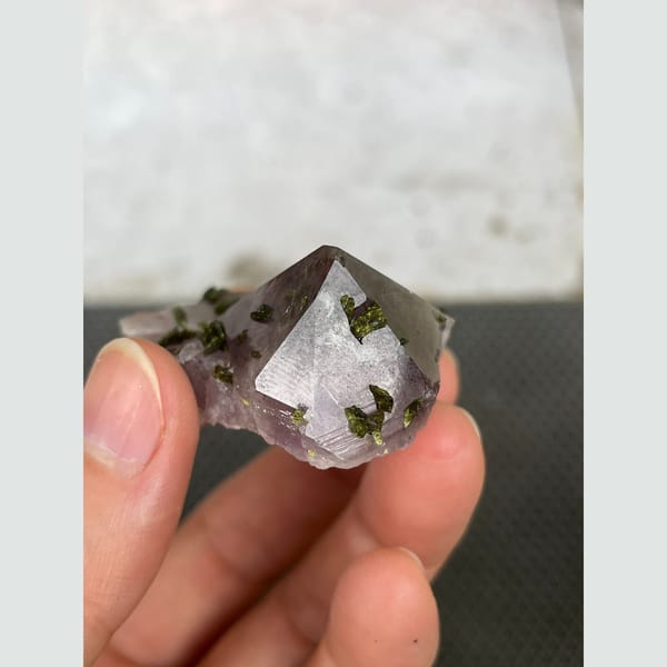 Lilac-tinted quartz with dark green epidote from Sichuan — detail view