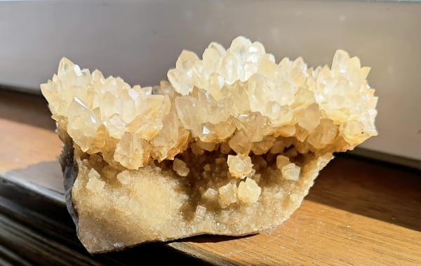 Complete reverse view showing the broad natural matrix and raised crystal groups