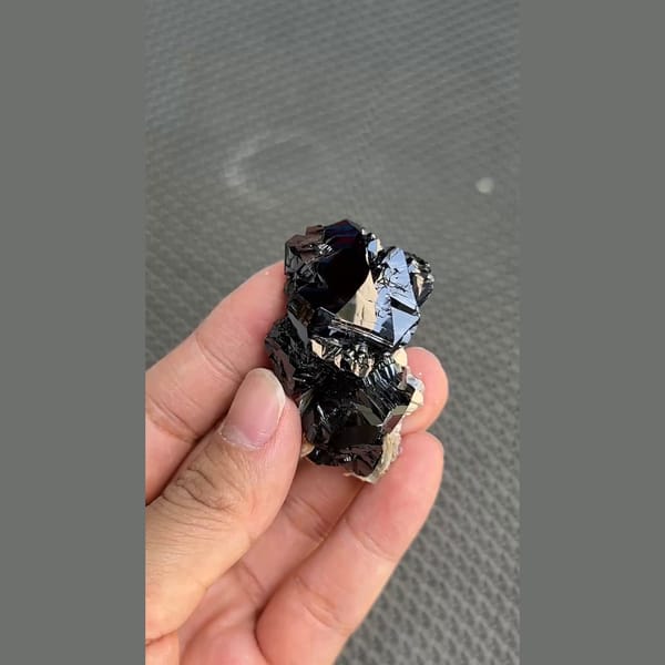 Mirror-bright black cassiterite crystal group from Xuebaoding, Sichuan — alternate view