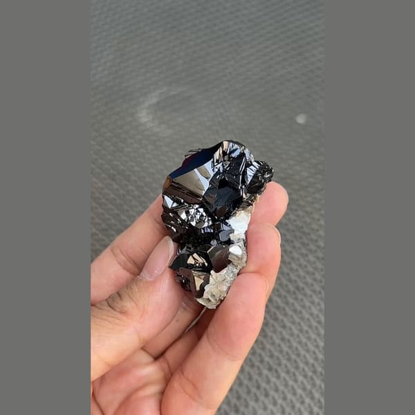 Mirror-bright black cassiterite crystal group from Xuebaoding, Sichuan — alternate view