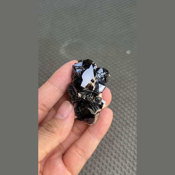 Mirror-bright black cassiterite crystal group from Xuebaoding, Sichuan — detail view