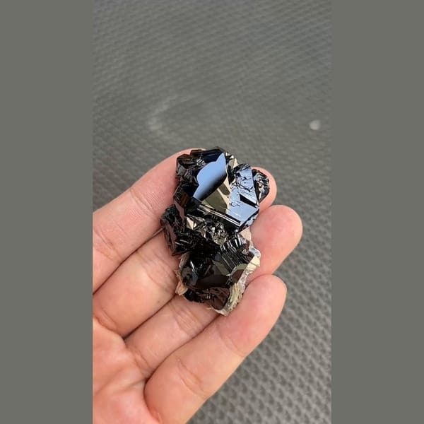 Mirror-bright black cassiterite crystal group from Xuebaoding, Sichuan — detail view