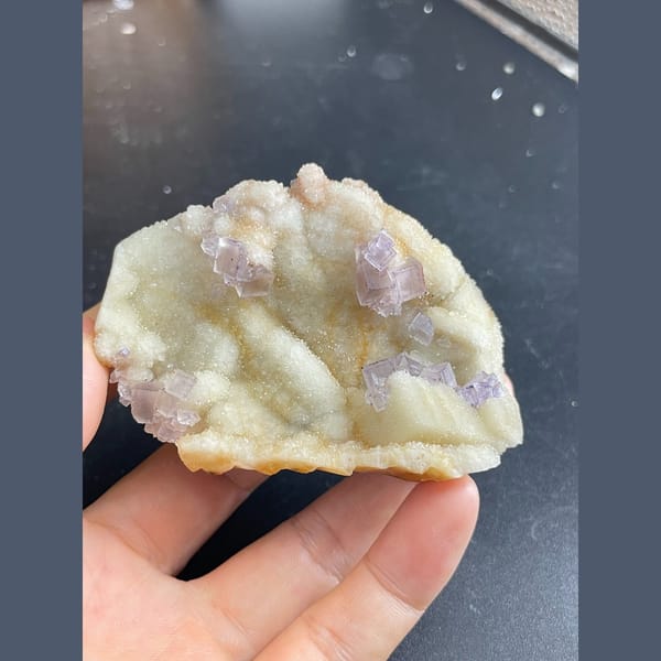 Lilac-purple fluorite cubes on white quartz from Guizhou — complete view