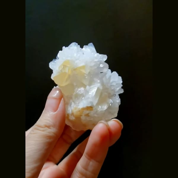 White cauliflower calcite flower with cyan UV glow — alternate view