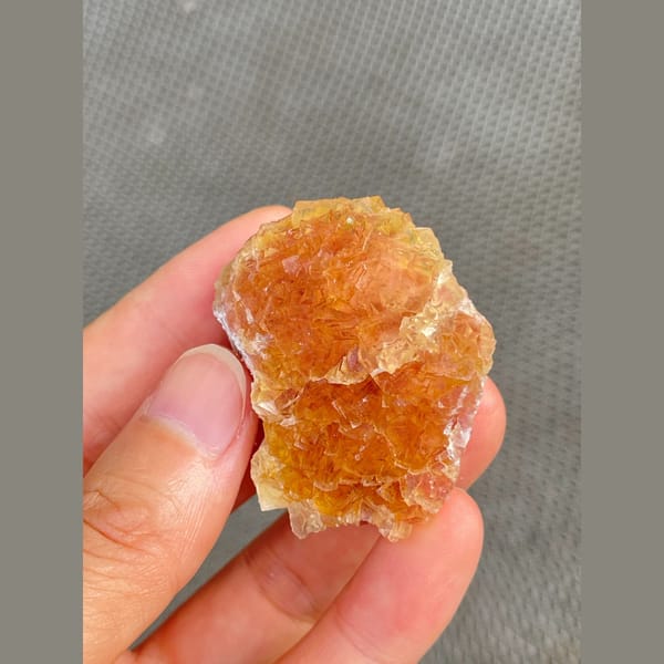 Amber-orange fluorite cluster from Henan — alternate view
