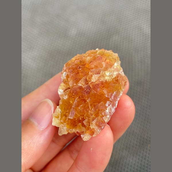 Amber-orange fluorite cluster from Henan — detail view