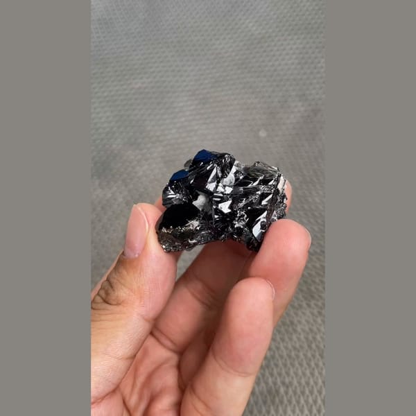 Branching cluster of lustrous black cassiterite from Xuebaoding, Sichuan — alternate view