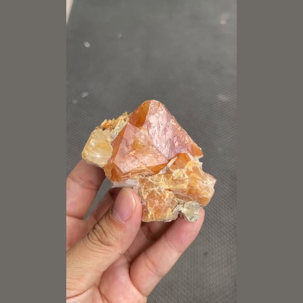 Chunky orange scheelite crystal on matrix from Xuebaoding, Sichuan — complete view