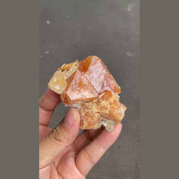 Chunky orange scheelite crystal on matrix from Xuebaoding, Sichuan — detail view