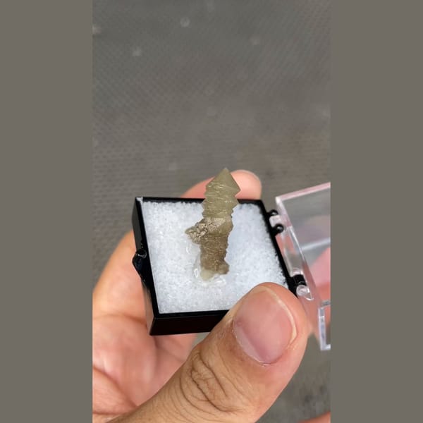 Small screw quartz crystal in display box from Inner Mongolia — detail view
