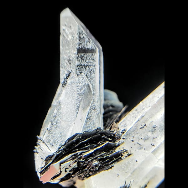 Clear quartz points with black bladed specular hematite from Guangdong — alternate view