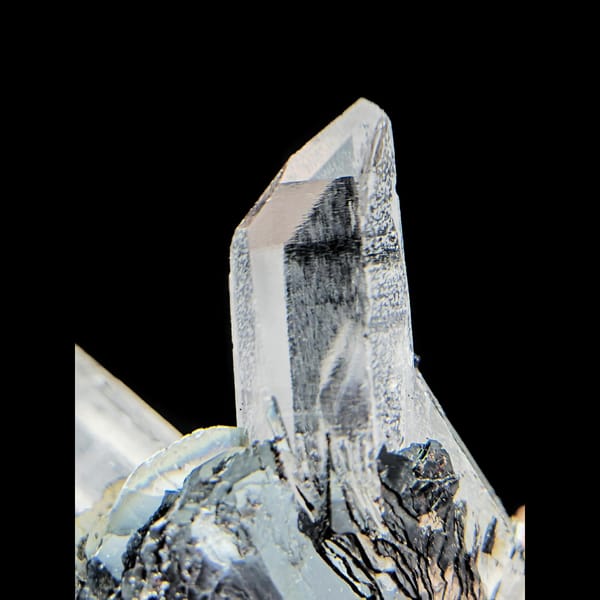 Clear quartz points with black bladed specular hematite from Guangdong — detail view