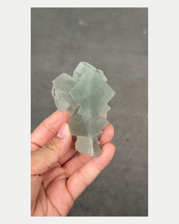 Complete front view of stacked green fluorite cluster