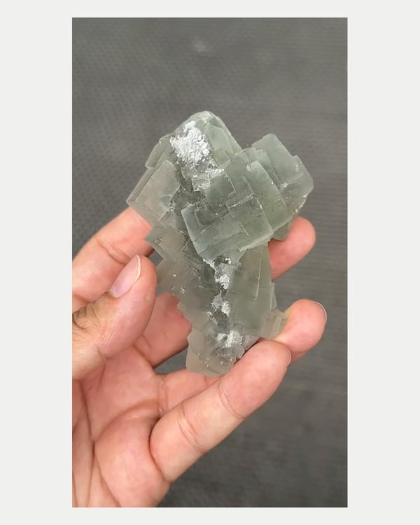 Complete left oblique view of stacked green fluorite cluster