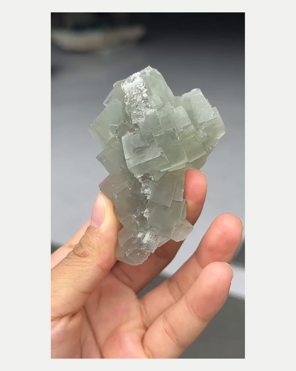 Complete right oblique view of stacked green fluorite cluster