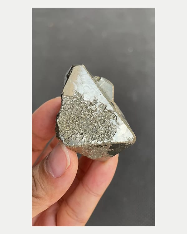 Complete broad face view of angular metallic pyrite crystal