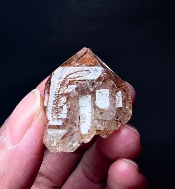 Five-Window Red-Clay Skeletal Quartz Point — Madagascar — individual mineral specimen view 3