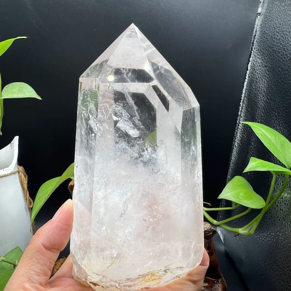 Clear quartz point with enclosed green tourmaline and white phantoms — alternate view