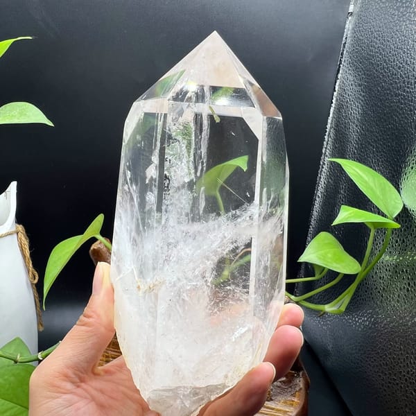 Clear quartz point with enclosed green tourmaline and white phantoms — alternate view