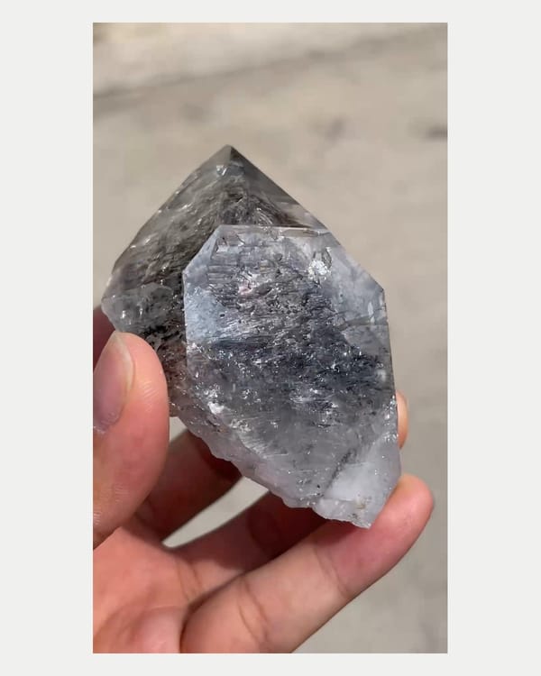 Complete reverse view of dark included quartz point
