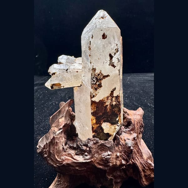 Large Himalayan quartz floater from Tibet on a wood stand — alternate view