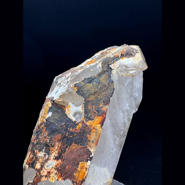 Large Himalayan quartz floater from Tibet on a wood stand — detail view