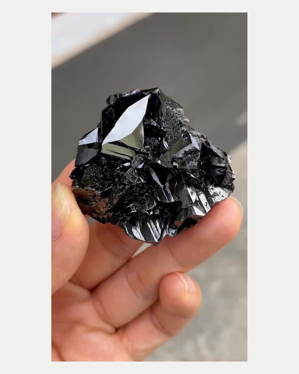 Complete front view of brilliant black cassiterite cluster