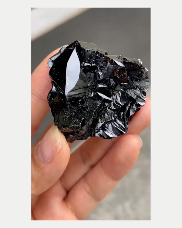 Complete left oblique view of brilliant black cassiterite cluster