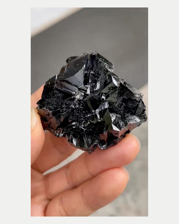 Complete reverse view of brilliant black cassiterite cluster
