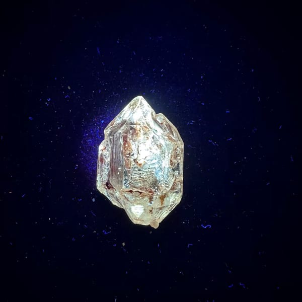 Red mud skeletal windowed quartz from Madagascar — complete view