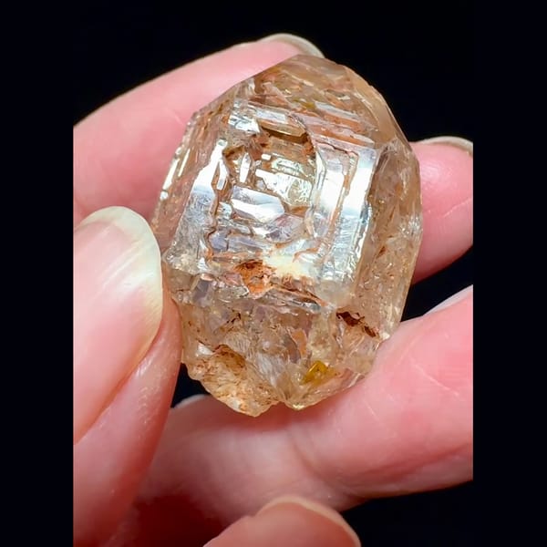 Red mud skeletal windowed quartz from Madagascar — detail view