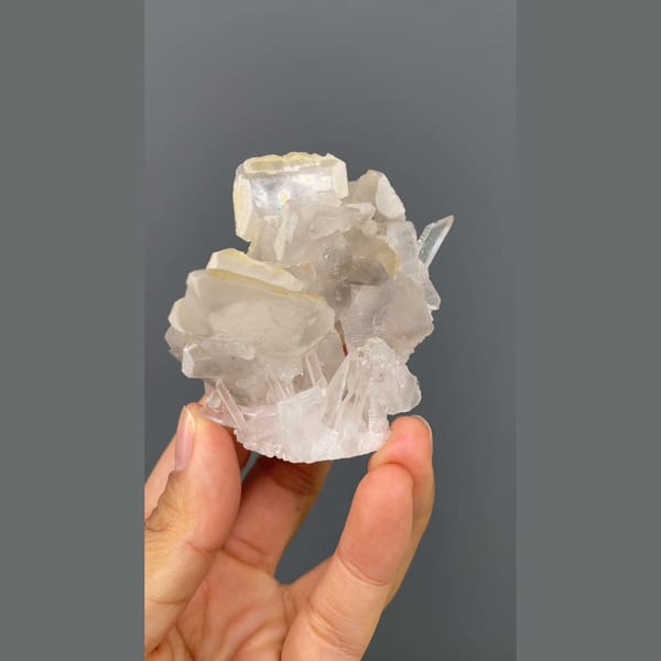 Glassy quartz cluster with white barite blades from Jinkouhe, Sichuan — alternate view
