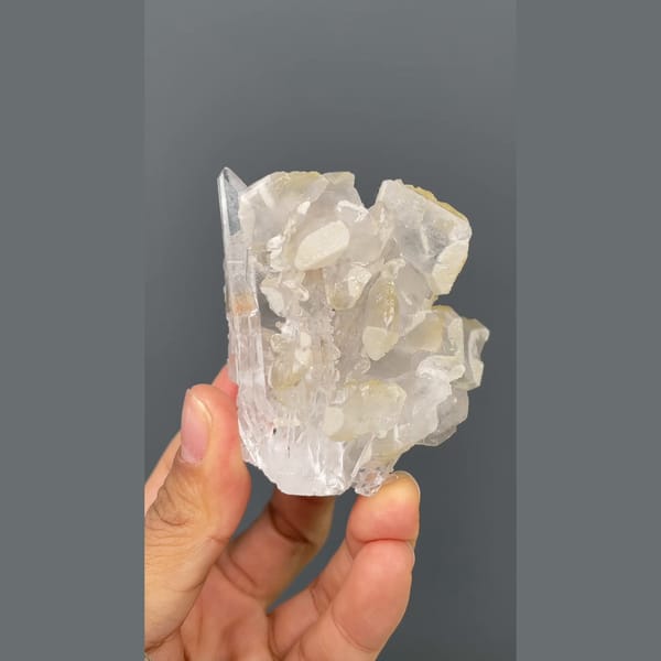 Glassy quartz cluster with white barite blades from Jinkouhe, Sichuan — detail view