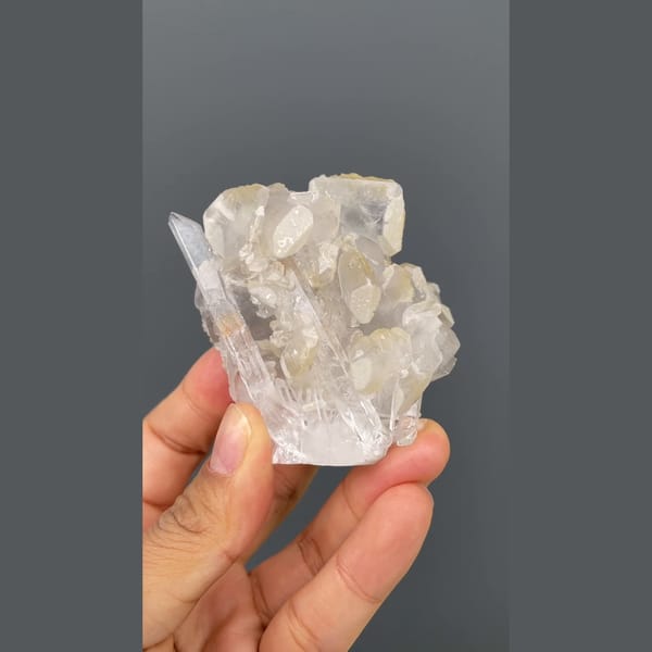Glassy quartz cluster with white barite blades from Jinkouhe, Sichuan — detail view