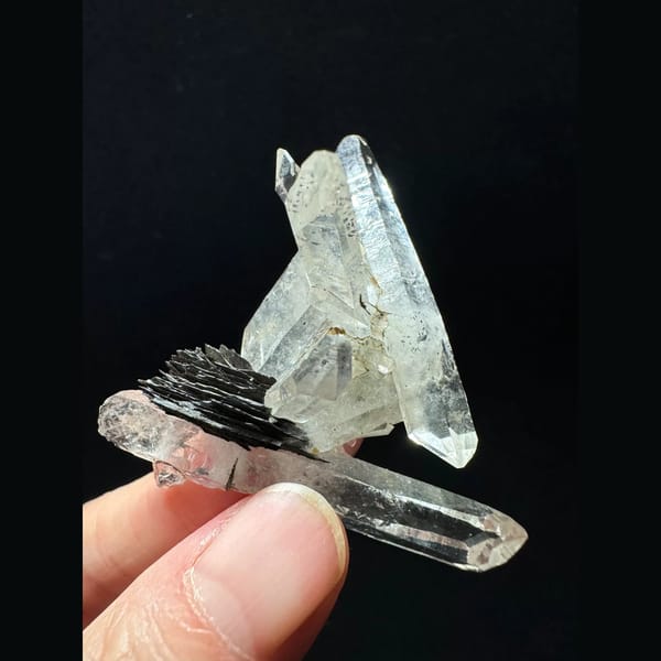 Double-terminated quartz cluster with hematite from Guangdong — detail view