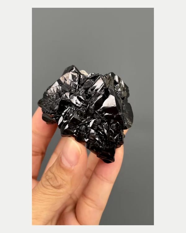 Complete front view of lustrous cassiterite crystal cluster
