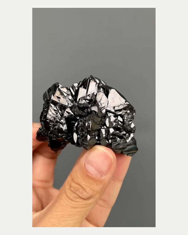 Complete left oblique view of lustrous cassiterite crystal cluster