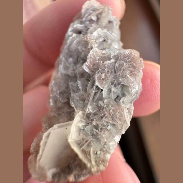 Small quartz with pale pink petal calcite and hematite from Inner Mongolia — detail view