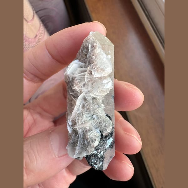 Quartz floater with pale pink petal calcite and hematite from Inner Mongolia — complete view