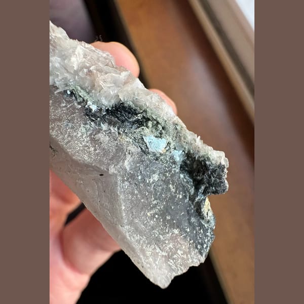 Quartz floater with pale pink petal calcite and hematite from Inner Mongolia — detail view
