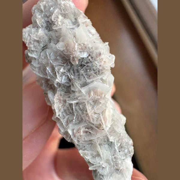 Quartz floater with pale pink petal calcite and hematite from Inner Mongolia — detail view