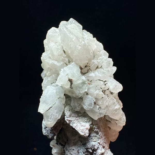 Quartz floater with white calcite and hematite from Inner Mongolia — detail view