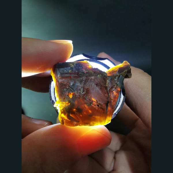 Sphalerite crystal from Inner Mongolia glowing orange when backlit — detail view