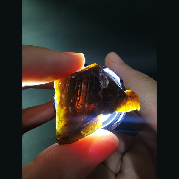 Sphalerite crystal from Inner Mongolia glowing orange when backlit — detail view