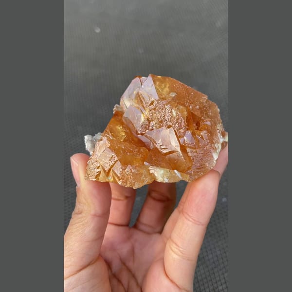 Orange scheelite floater with translucent tip from Xuebaoding, Sichuan — alternate view