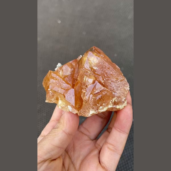 Orange scheelite floater with translucent tip from Xuebaoding, Sichuan — detail view